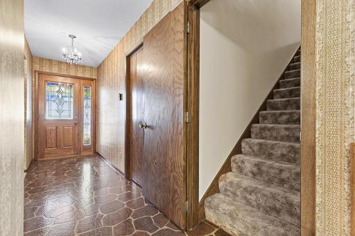 An entry closet is nearby for coats and outdoor wear, and access to the second story is found here.