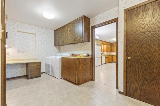 Laundry is just inside the attached garage and leads to the kitchen and basement