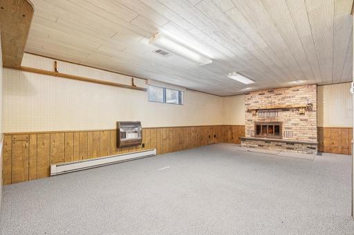 A large family room with brick fireplace