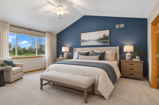Retreat to the spacious primary suite featuring a vaulted ceiling, designer accent wall, abundant natural light, and serene views overlooking the Boulder Pointe Golf Course. Virtual staging.