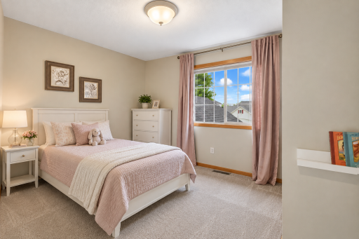 Spacious second bedroom upstairs featuring a large window, plush carpeting, and ample space for family, guests, or a home office. Virtual staging.