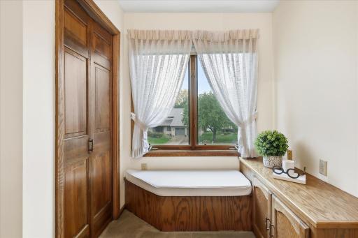 Upper-Level Built-In: Charming built-in cabinetry and window seat create a functional nook with additional storage and natural light.