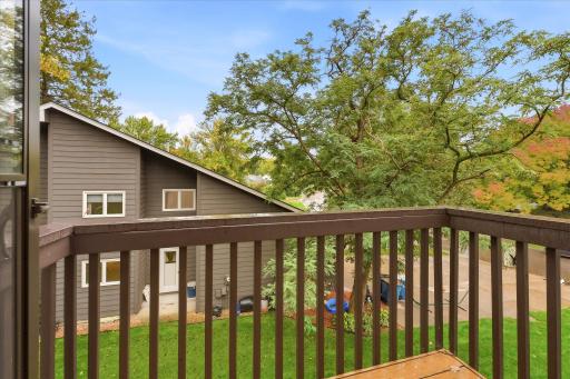 Step outside to a private balcony overlooking mature trees and the surrounding neighborhood.