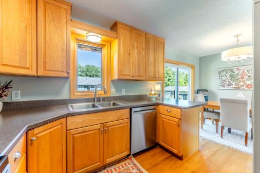 Kitchen window overlooks deck and backyard.