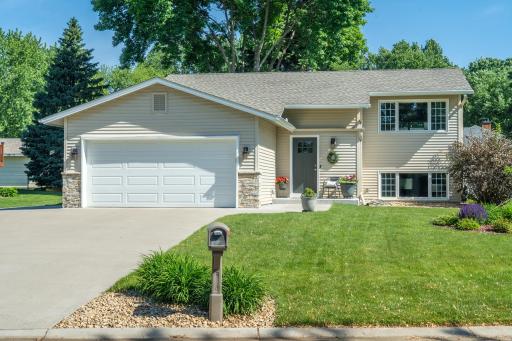 The covered front entry is framed by lush landscaping and a lawn that's clearly been loved. Welcome home.