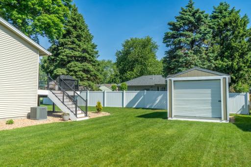 Large side yard and drive in storage shed.