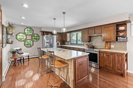 The main-floor kitchen offers a large island, plenty of cabinetry, and stainless-steel appliances.