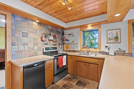 A closer look at the lower kitchen's storage, appliances, and workspace.