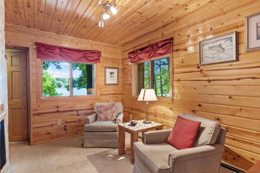 A cozy wood-paneled sitting room offers a quieter place to unwind.