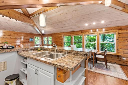 The Guest Suite kitchen includes an island sink, plenty of counter space, and lots of windows.