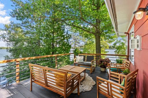 A comfortable upper deck with room for outdoor dining under the trees.