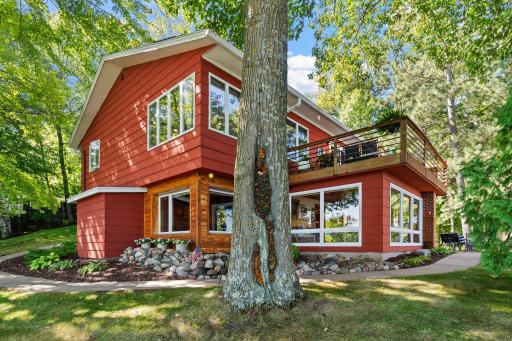 Large windows and outdoor living spaces make the most of the lakeside setting.