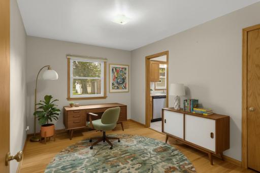 The third bedroom on the main floor is virtually staged as an office.