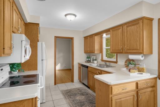 Enjoy updated appliances, tile floors, and real wood cabinetry.