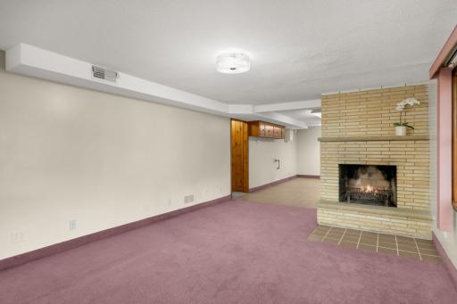 The lower level features the second wood-burning fireplace.