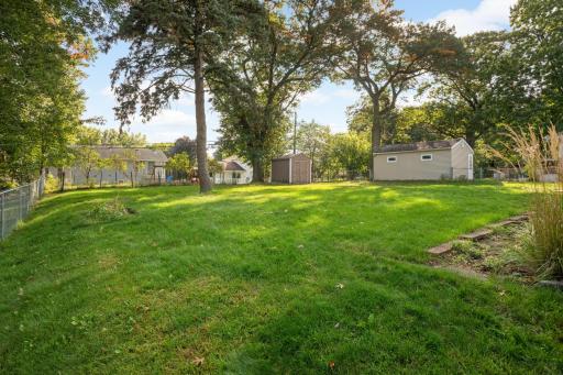 The backyard is partially fenced and features a nice storage shed and beautiful garden area.