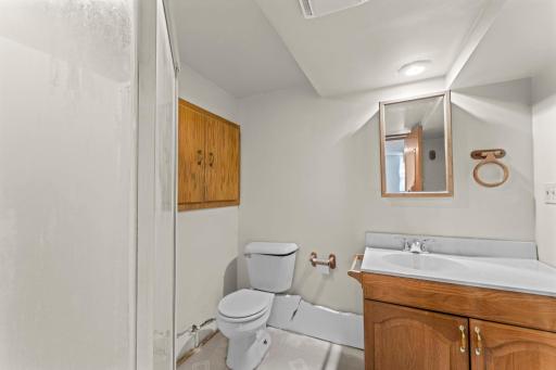Lower 3/4 bathroom is located in primary bedroom