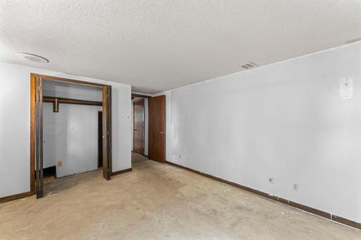 Bedroom #3. Access to under the front stairs is through the closet area.