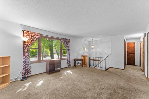 Living room and view down hall to full bathroom and 2 bedrooms
