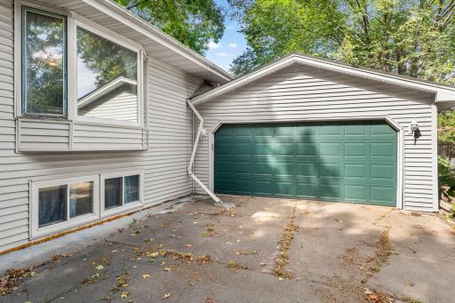 View of side of home where addition is along with 2 car garage