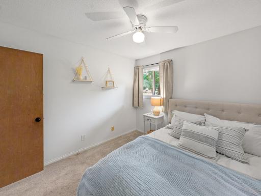 Two windows and a ceiling fan make this bedroom also feel like home.