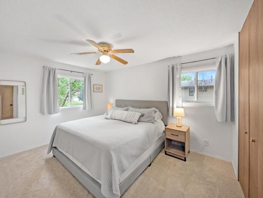 Bedroom one on the upper level features three windows and a ceiling fan!