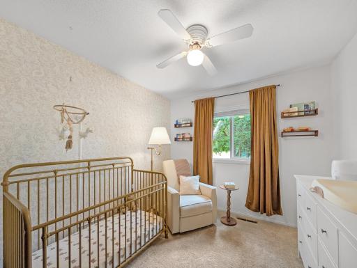 Bedroom three on the upper level. Currently staged as a nursery, this room is an ideal office space, playroom, or hobby room as well!