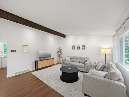 Living room on the main level features plenty of natural light supplanted by recessed lighting for a bright atmosphere!