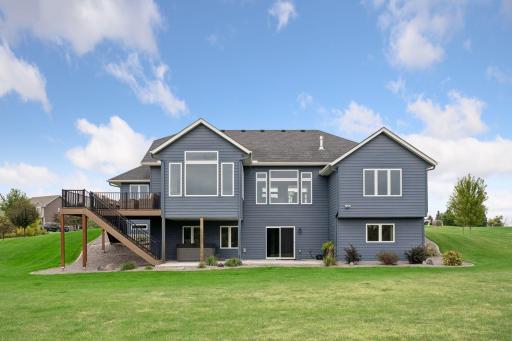 Rear with concrete patio and hot tub