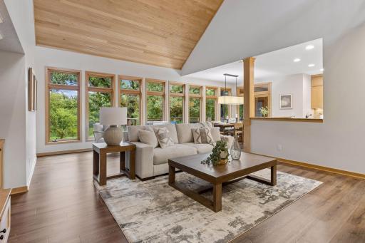 Spacious & sophisticated great room with soaring ceilings and wall of windows, bring in the beautiful outdoor views.
