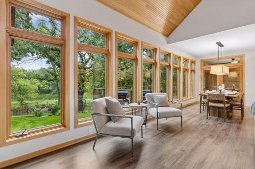 Walls of windows with incredible views of the outdoor space including raised garden beds, large deck and a charming chicken coop.