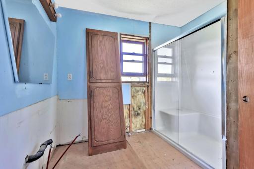 Main level partially finished 3/4 bath with walk-in shower.
