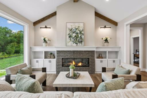 Living room showcases a gorgeous gas fireplace and built-ins