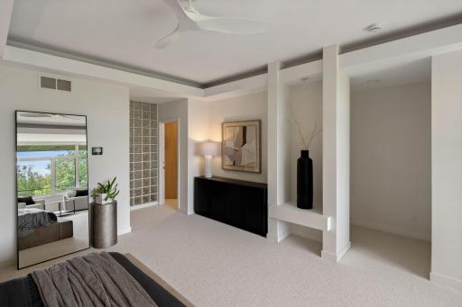 Primary bedroom w/glass block allowing light in to Primary Private Shower Space. Access to large walk-in closet with custom storage.