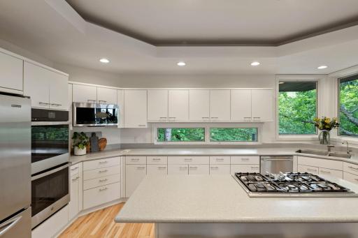 New oven and microwave undercabinet windows view into woods.