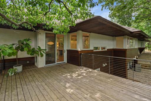 Large deck with new cable railing off informal dining.