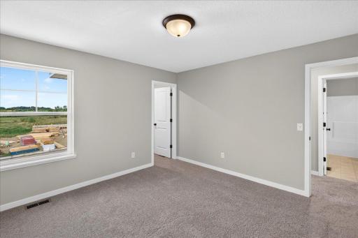 PHOTO OF A DIFFERENT HOME WITH SIMILAR PLAN AND FINISHES. Bedroom 2.