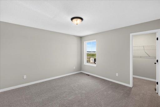 PHOTO OF A DIFFERENT HOME WITH SIMILAR PLAN AND FINISHES. Bedroom 2.