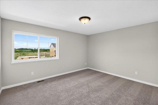 PHOTO OF A DIFFERENT HOME WITH SIMILAR PLAN AND FINISHES. Bedroom 3.