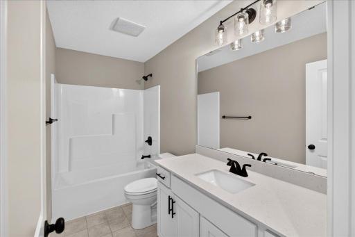 PHOTO OF A DIFFERENT HOME WITH SIMILAR PLAN AND FINISHES. Upper Main Bathroom.