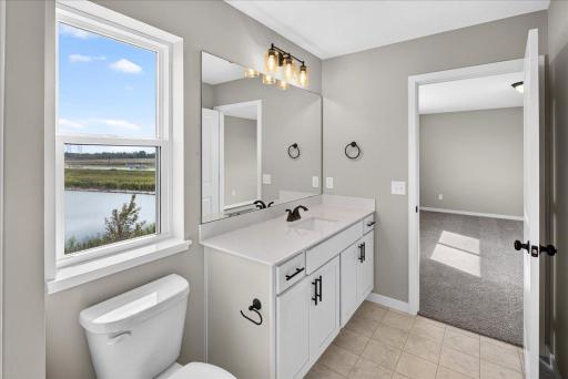 PHOTO OF A DIFFERENT HOME WITH SIMILAR PLAN AND FINISHES. Primary Suite Walk-in Closet.