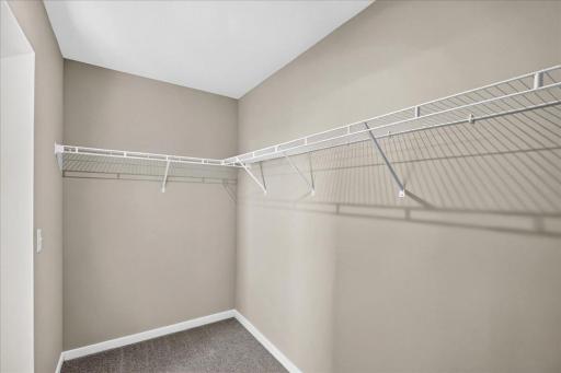 PHOTO OF A DIFFERENT HOME WITH SIMILAR PLAN AND FINISHES. Primary Suite Walk-in Closet.