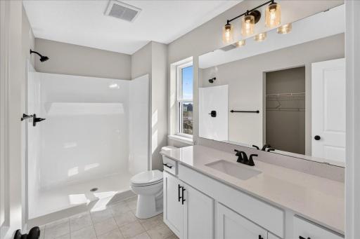 PHOTO OF A DIFFERENT HOME WITH SIMILAR PLAN AND FINISHES. Primary Suite Private Bathroom.