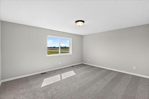 PHOTO OF A DIFFERENT HOME WITH SIMILAR PLAN AND FINISHES. Primary Suite.