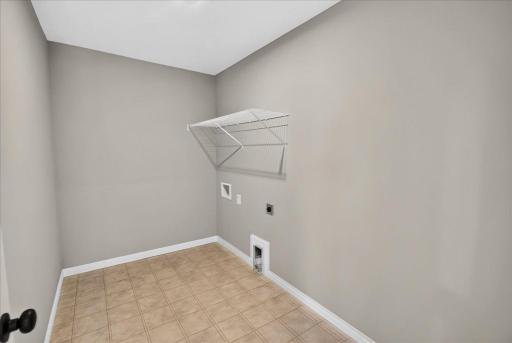 PHOTO OF A DIFFERENT HOME WITH SIMILAR PLAN AND FINISHES. Upper Floor Laundry Room.