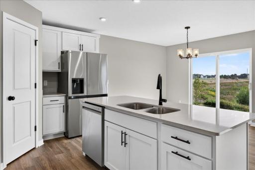 PHOTO OF A DIFFERENT HOME WITH SIMILAR PLAN AND FINISHES.
