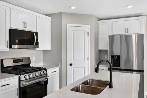 PHOTO OF A DIFFERENT HOME WITH SIMILAR PLAN AND FINISHES.