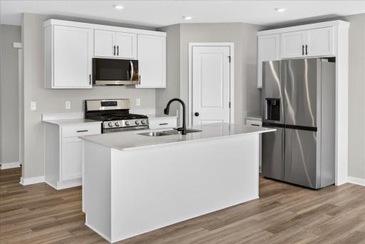 PHOTO OF A DIFFERENT HOME WITH SIMILAR PLAN AND FINISHES.