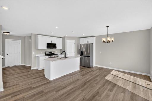 PHOTO OF A DIFFERENT HOME WITH SIMILAR PLAN AND FINISHES.