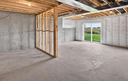 PHOTO OF A DIFFERENT HOME WITH SIMILAR PLAN AND FINISHES. Unfinished Walkout Lower Level.